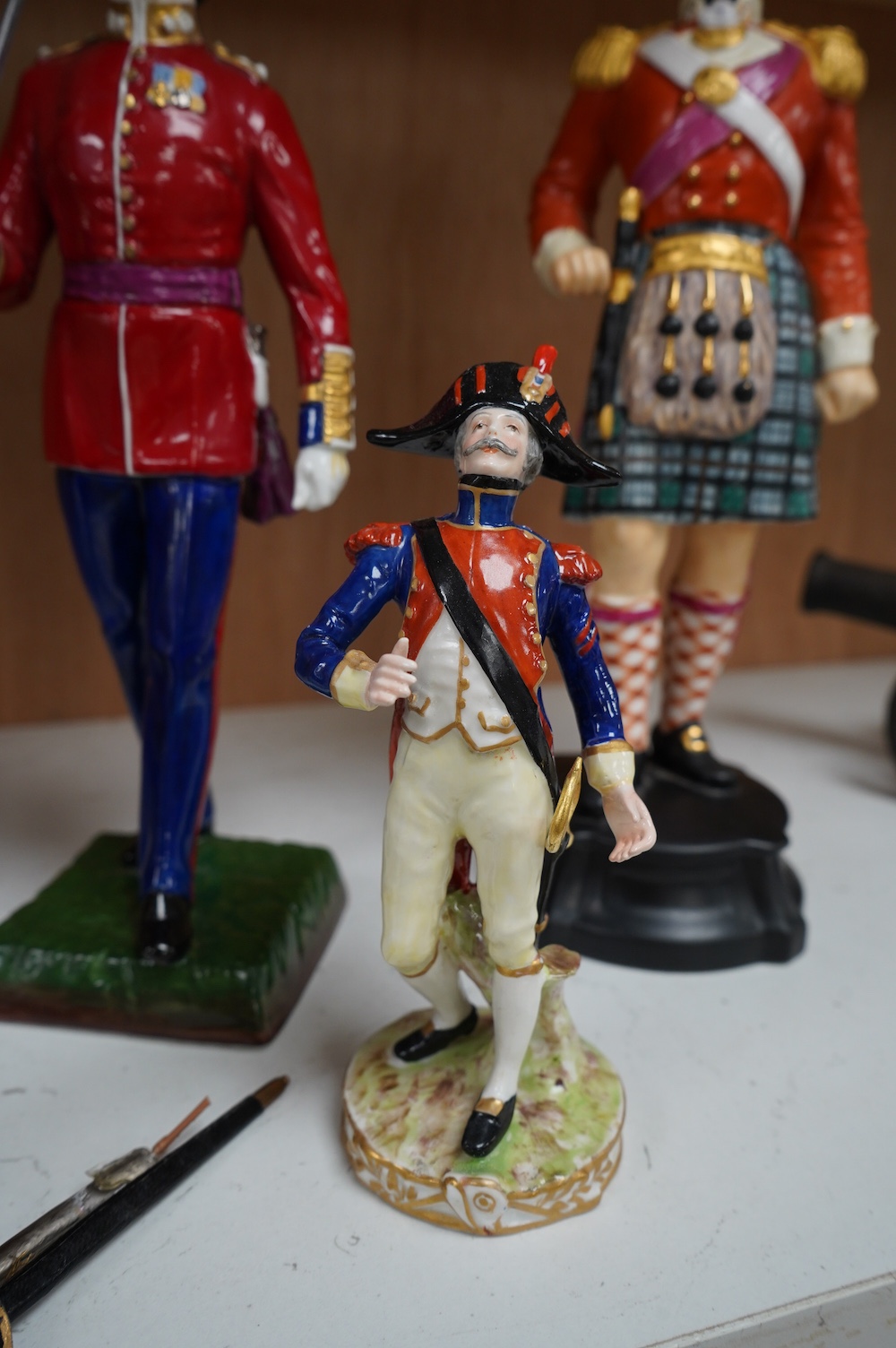 A pair of Sevres style Napoleonic figures and three others including Worcester, tallest 30cm. Condition - fair to good